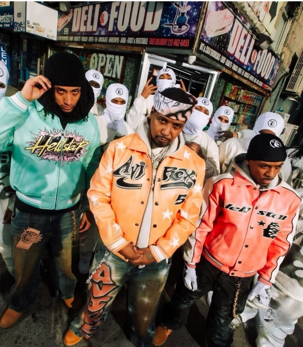 Three men wearing branded jackets in an urban setting with a store in the background.