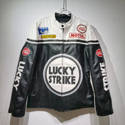 Black and white leather jacket with Lucky Strike branding on a hanger against a gray background