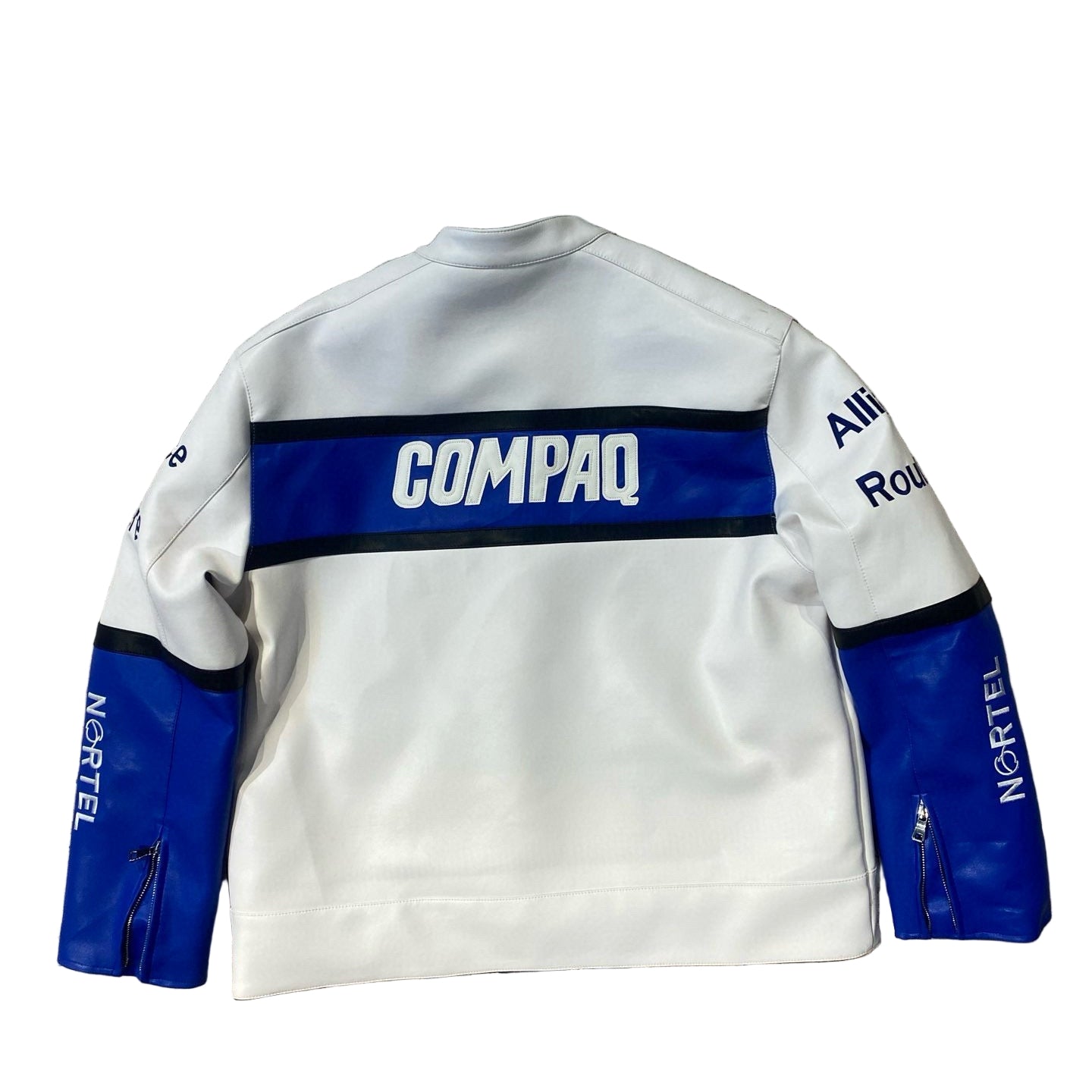 White sweatshirt with blue accents and visible branding on a textured stone wall.