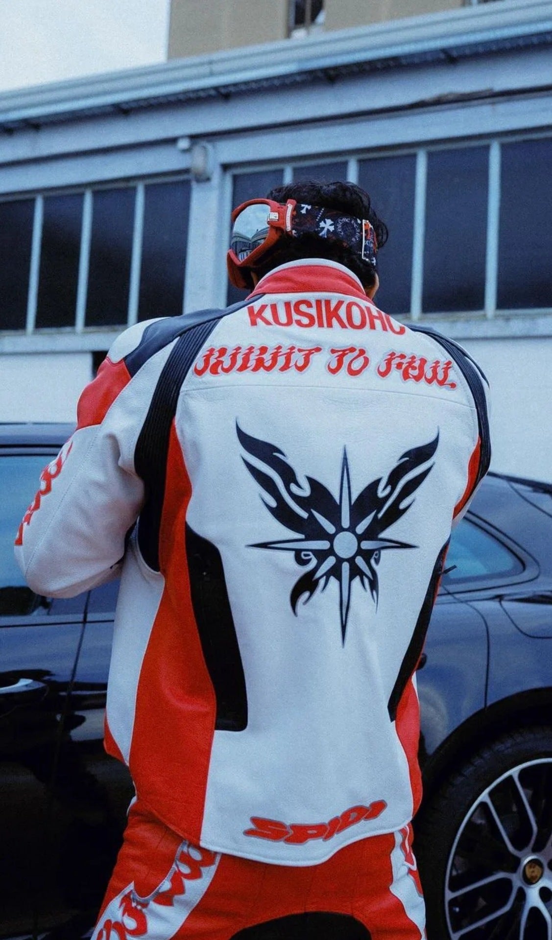 Person wearing a racing suit with visible branding and design elements.