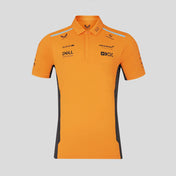 Orange polo shirt with black accents and brand logos on a light gray background