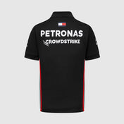 Black polo shirt with Petronas and CrowdStrike branding on a light gray background