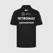 Black polo shirt with Mercedes-Benz and Petronas logos on a light gray background