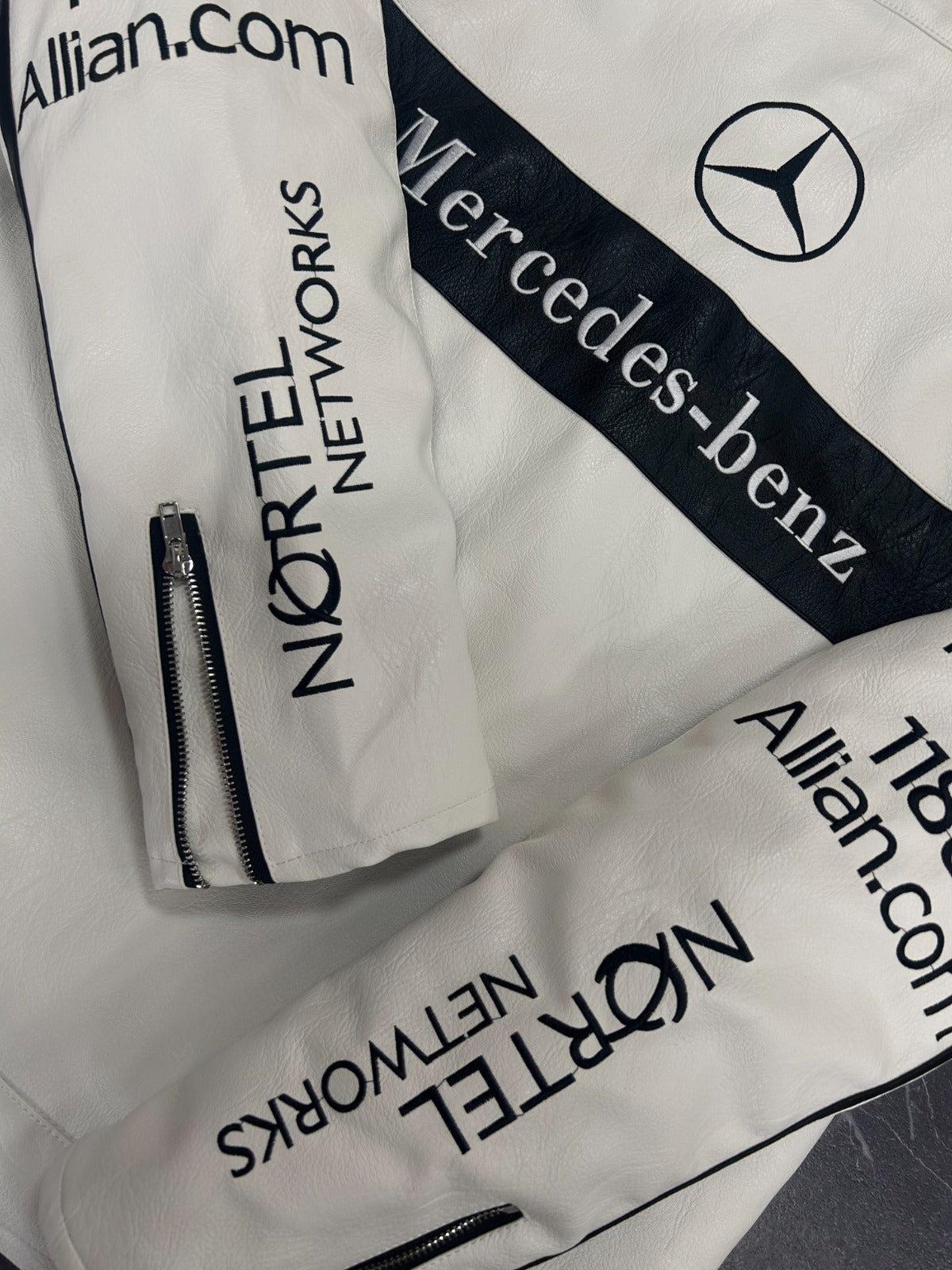 White bags with Mercedes-Benz and Nortel Networks branding on a white background
