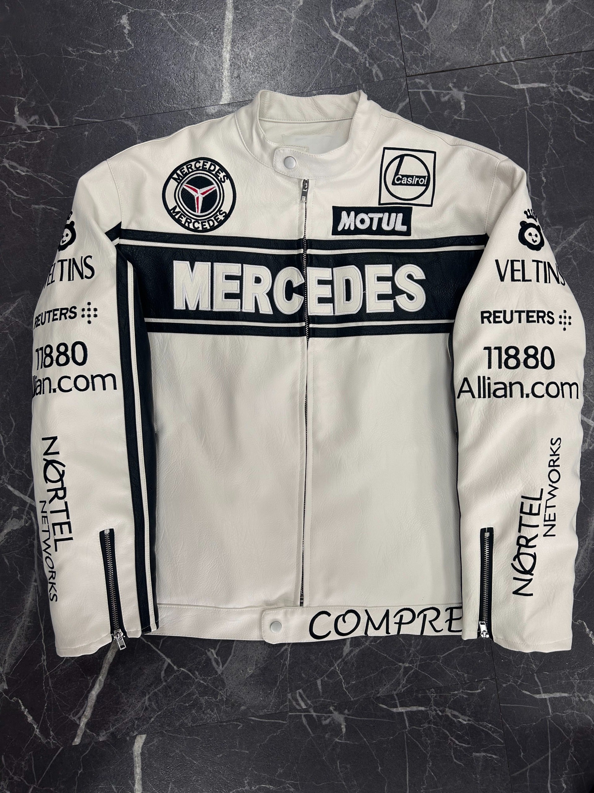White leather jacket with Mercedes and Motul branding on a dark textured background