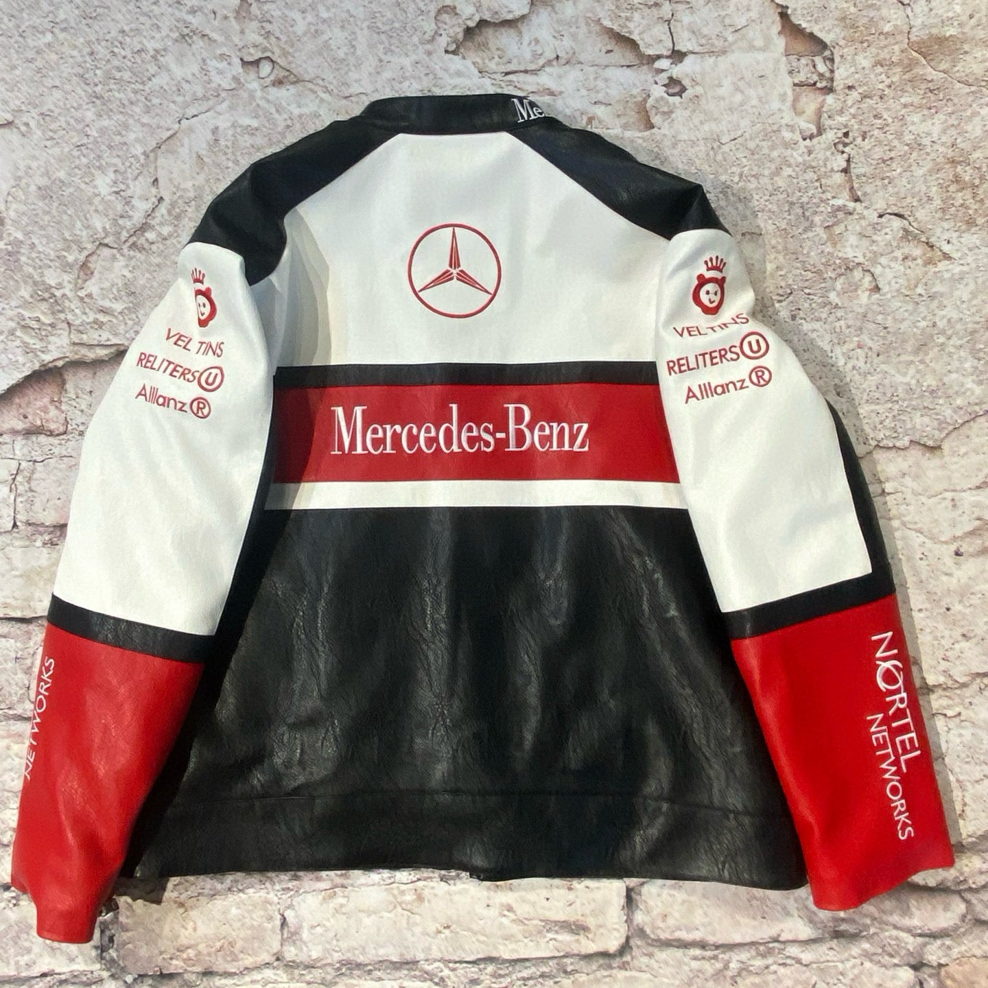 Mercedes-Benz leather jacket with branding on a textured stone background