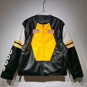 Black leather jacket with yellow center and white sleeves on a hanger against a gray background