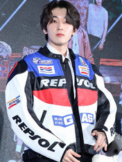 Person wearing a Repsol jacket with logos in a studio setting